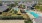 a group of houses with a swimming pool and trees