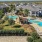 a group of houses with a swimming pool and trees