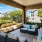 a patio with a fence and a patio with a view of a house