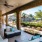 a living room with a fence and a patio with a large glass wall