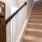 a staircase with a painting on the wall