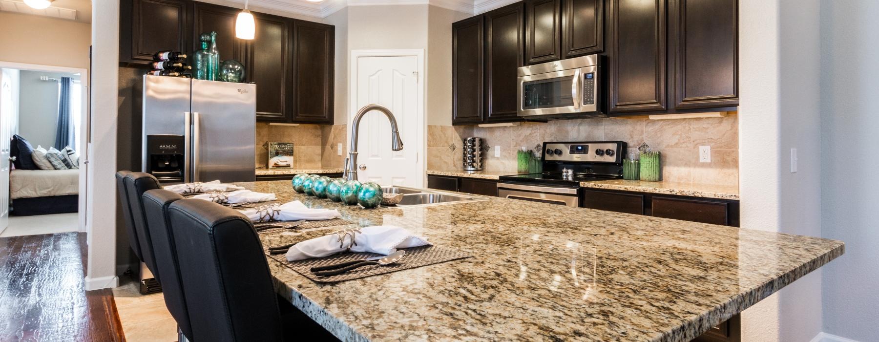 a kitchen with a marble island
