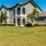 a large house with a lawn in front of it